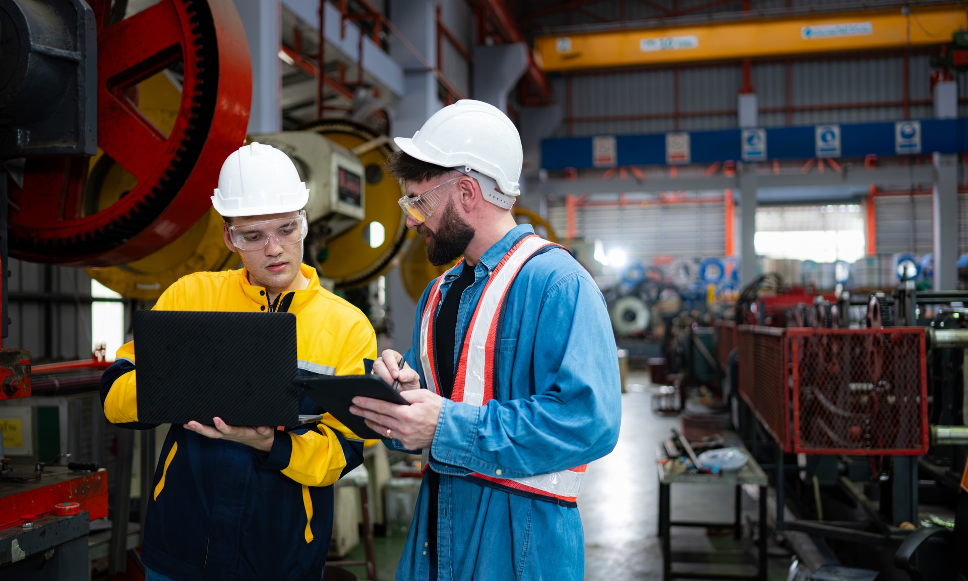 Engineer and technician discussing machinery in factory to plan inspection maintenance according to usage cycle, Concepts inspections based on usage cycle maintenance